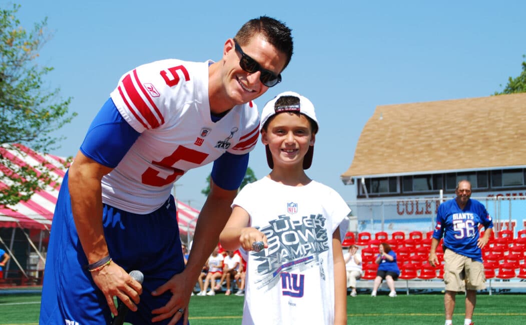 Steve Weatherford photo with young camper wearing his superbowl ring