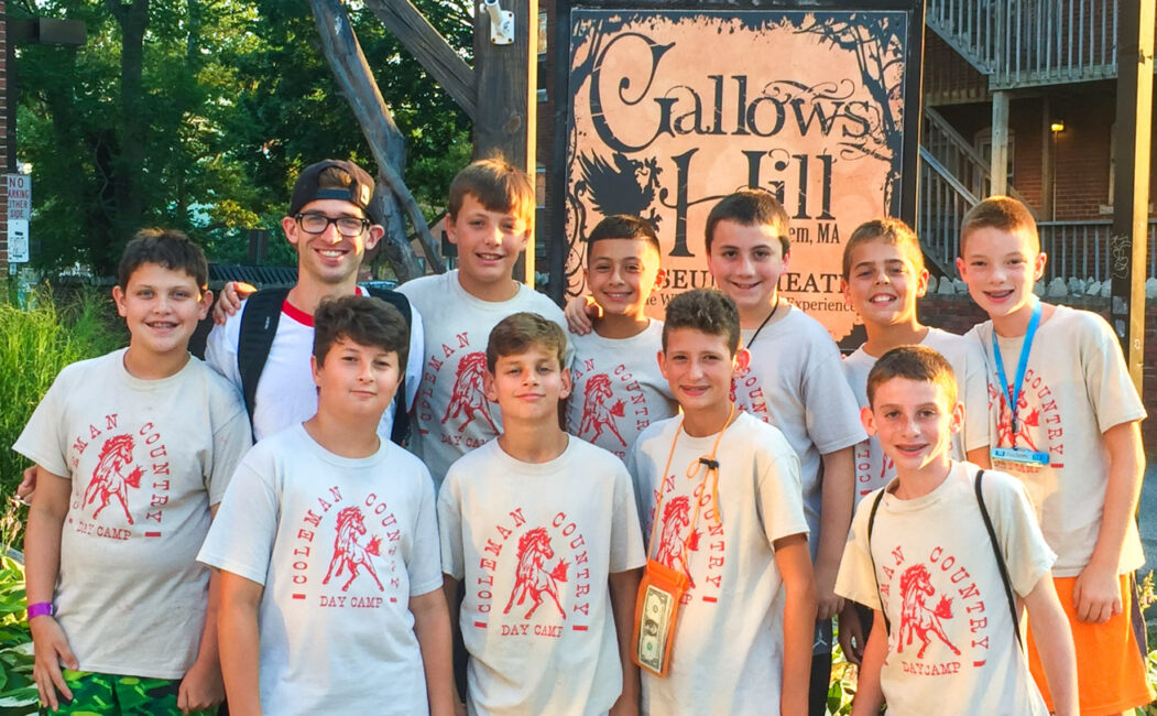 Group of boy campers standing in front of Gallows Hill sign