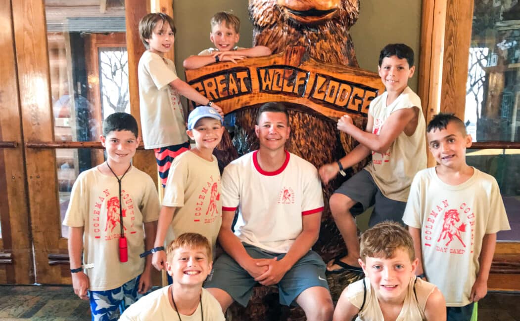 Group of boy campers in front of Great Wolf Lodge sign