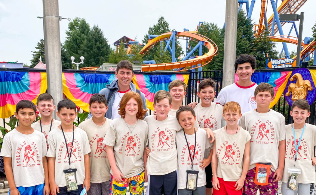 Group photo of campers at a theme park.