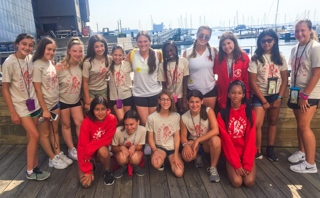 Group of girl campers on a dock at a marina
