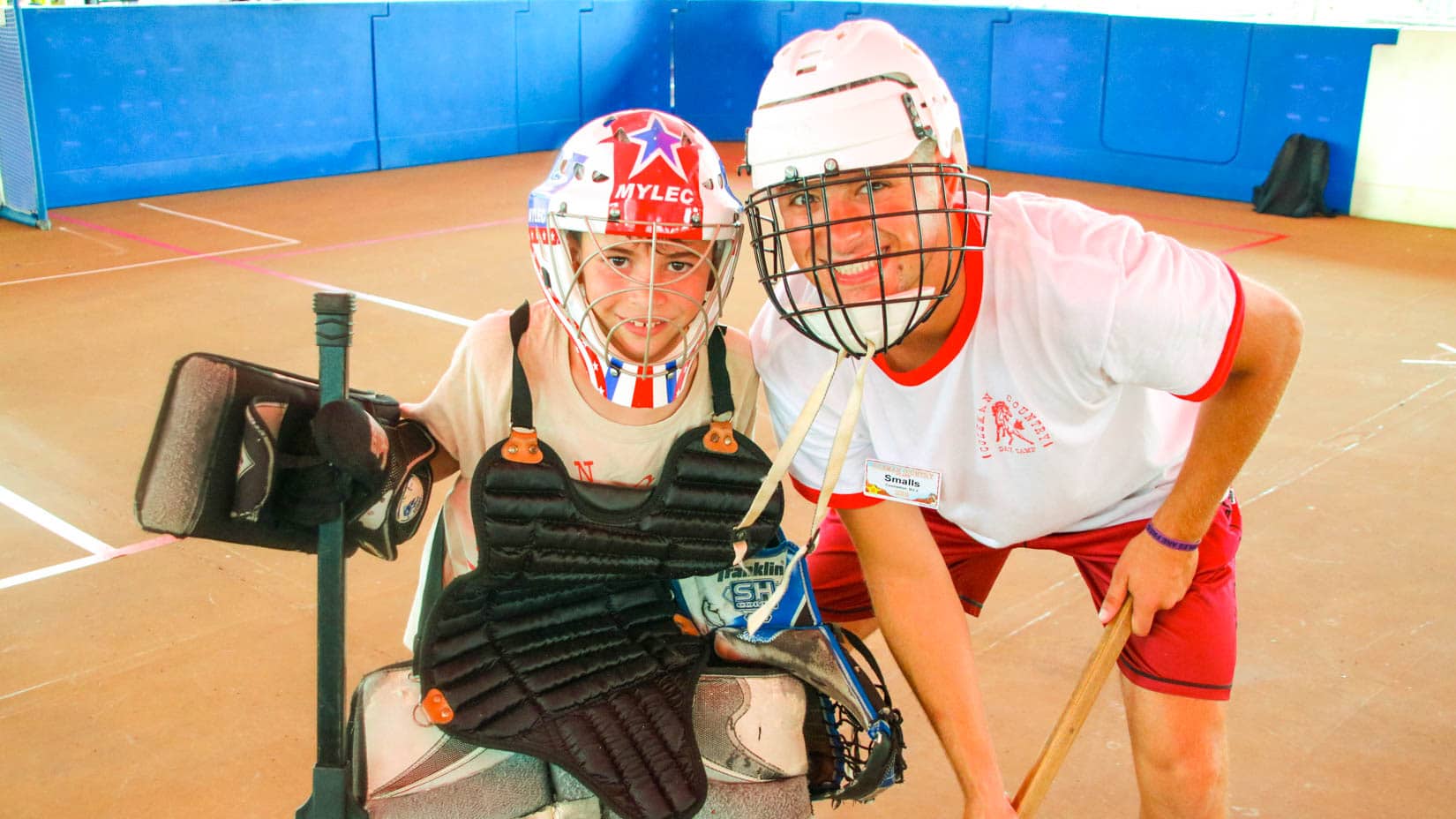 Camper and counselor in hockey gear.