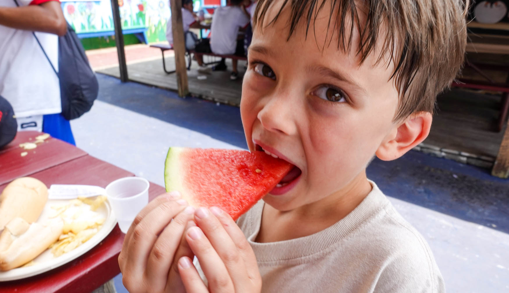 Camper eating a slice of watermelon.