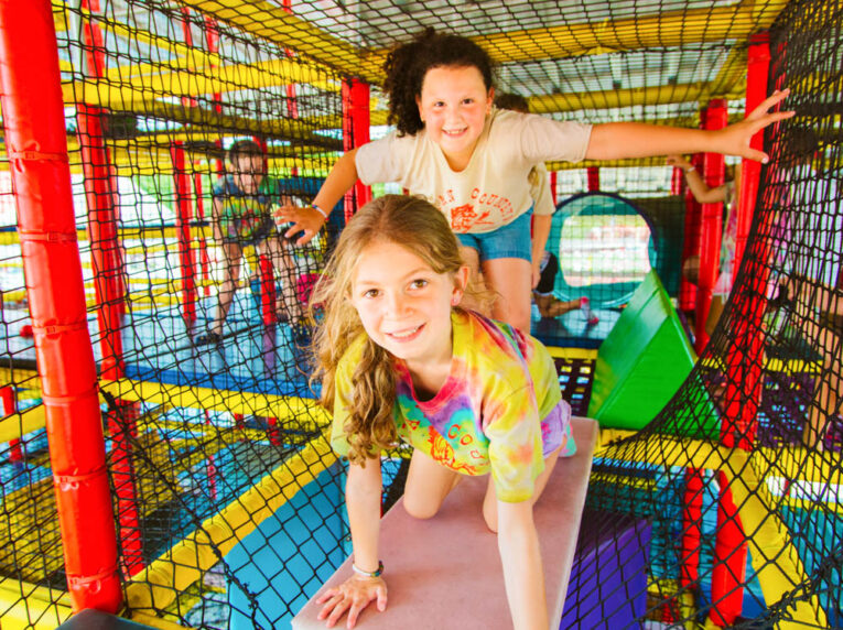 Campers playing in a play structure.