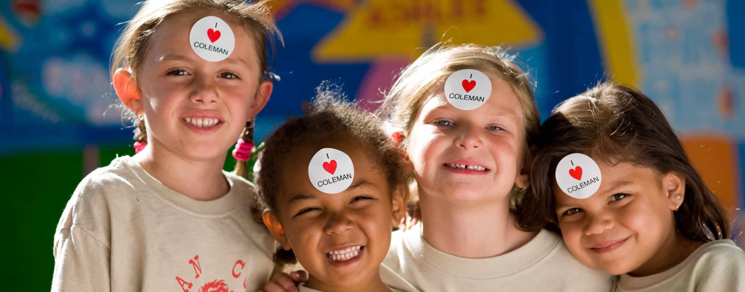 Campers smiling with stickers on their foreheads.