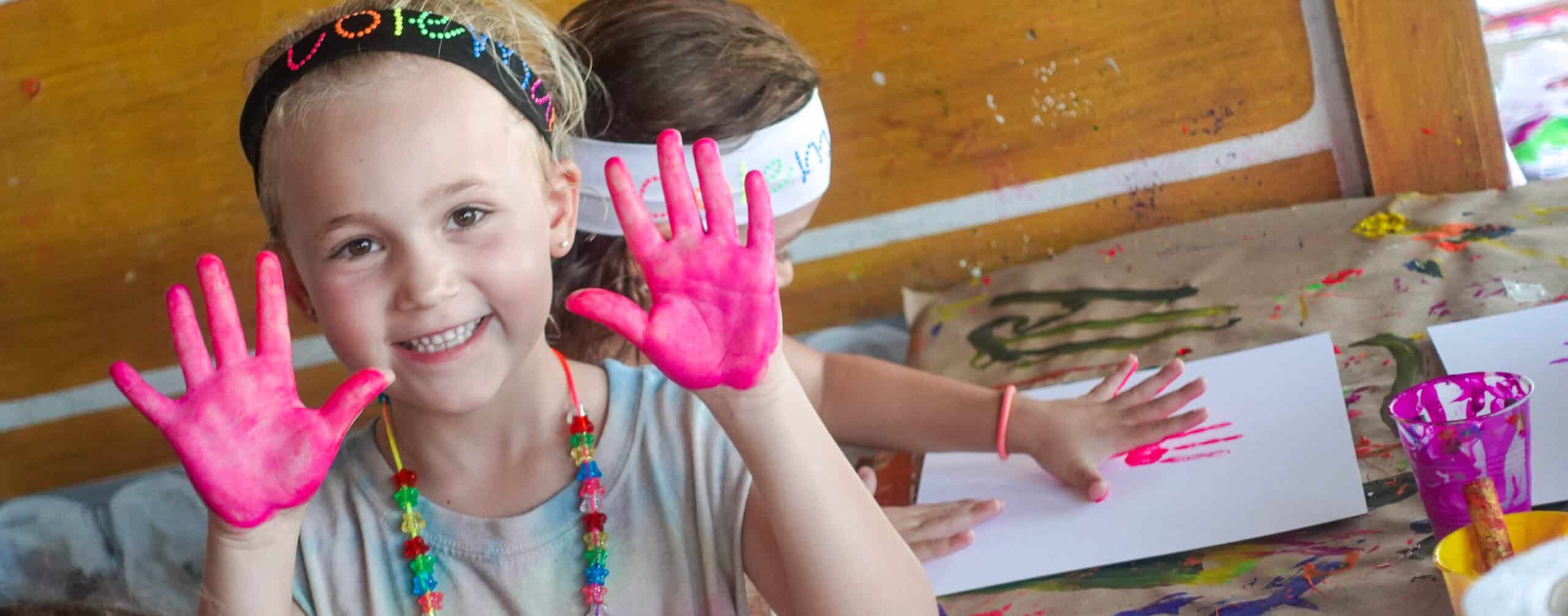 Camper painting with her hands.