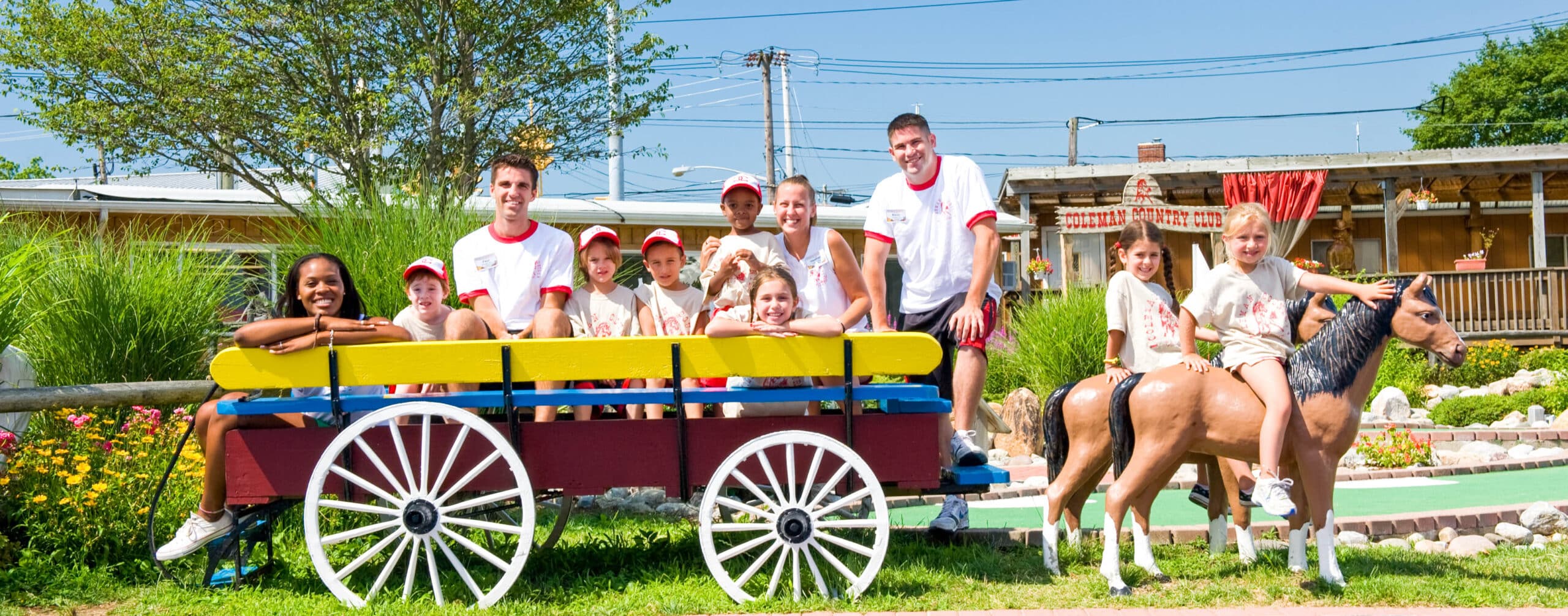 Campers and counselors sitting in a wagon.