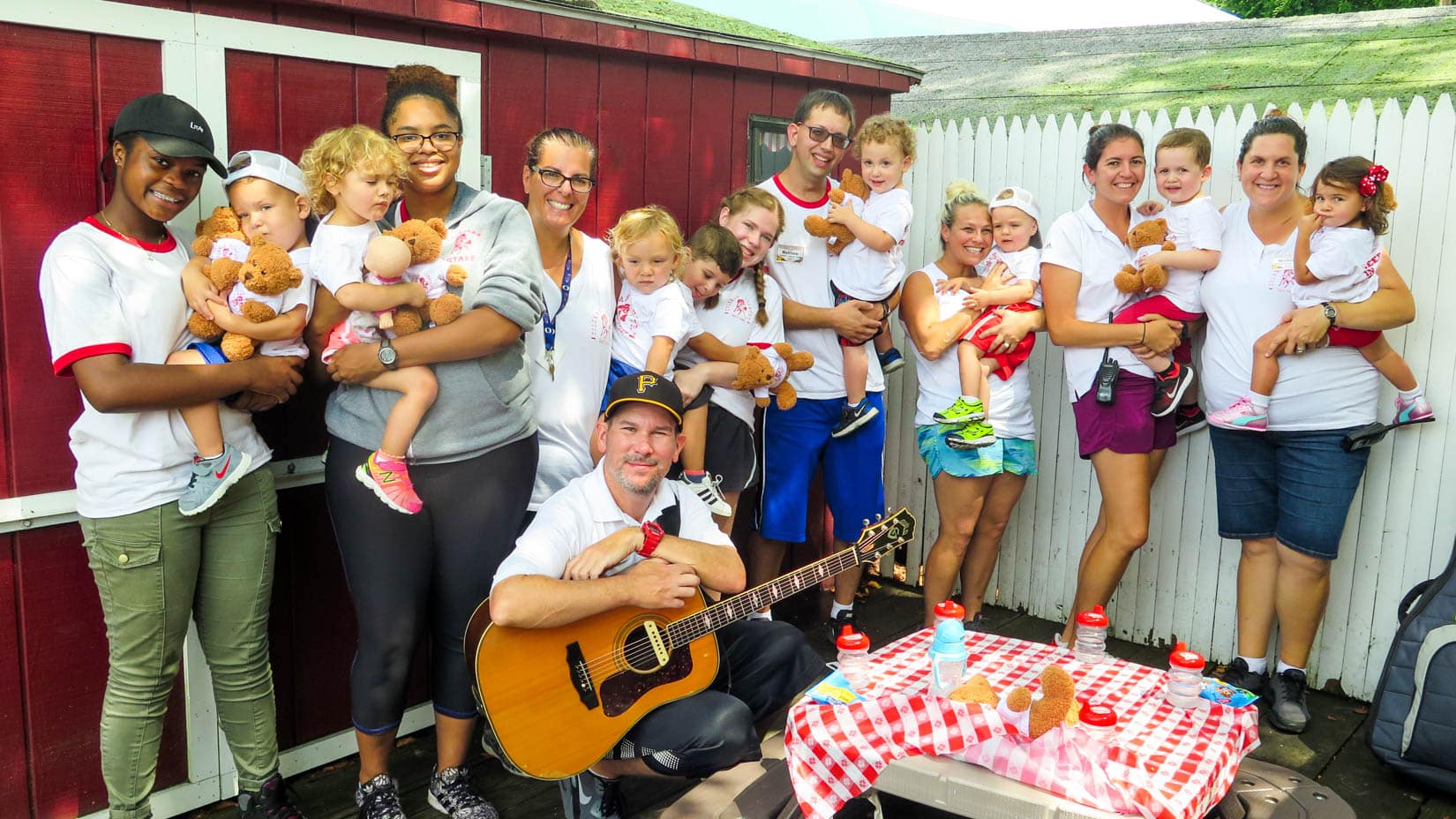 Staff group photo with their kids.