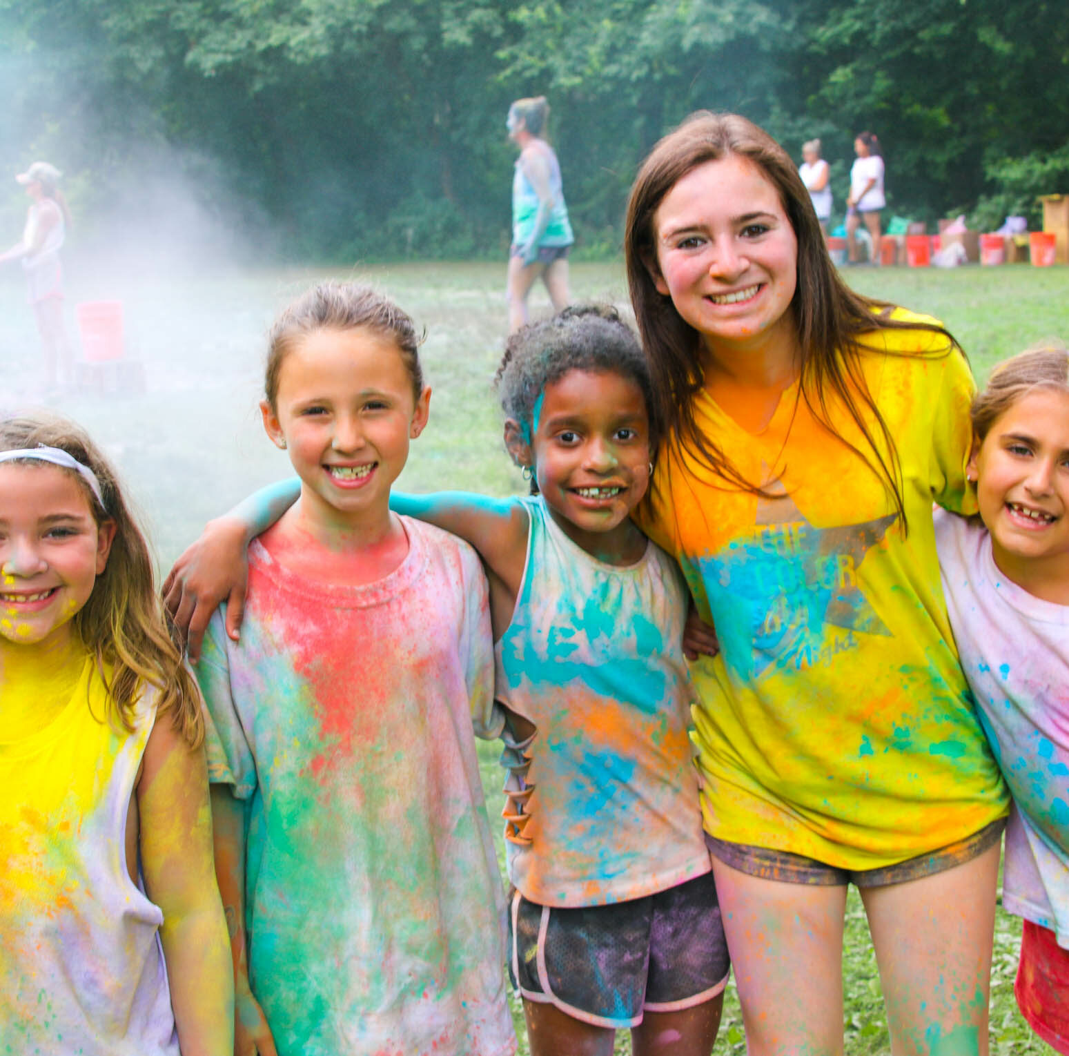 Staff and campers with colored shirts after the color run.