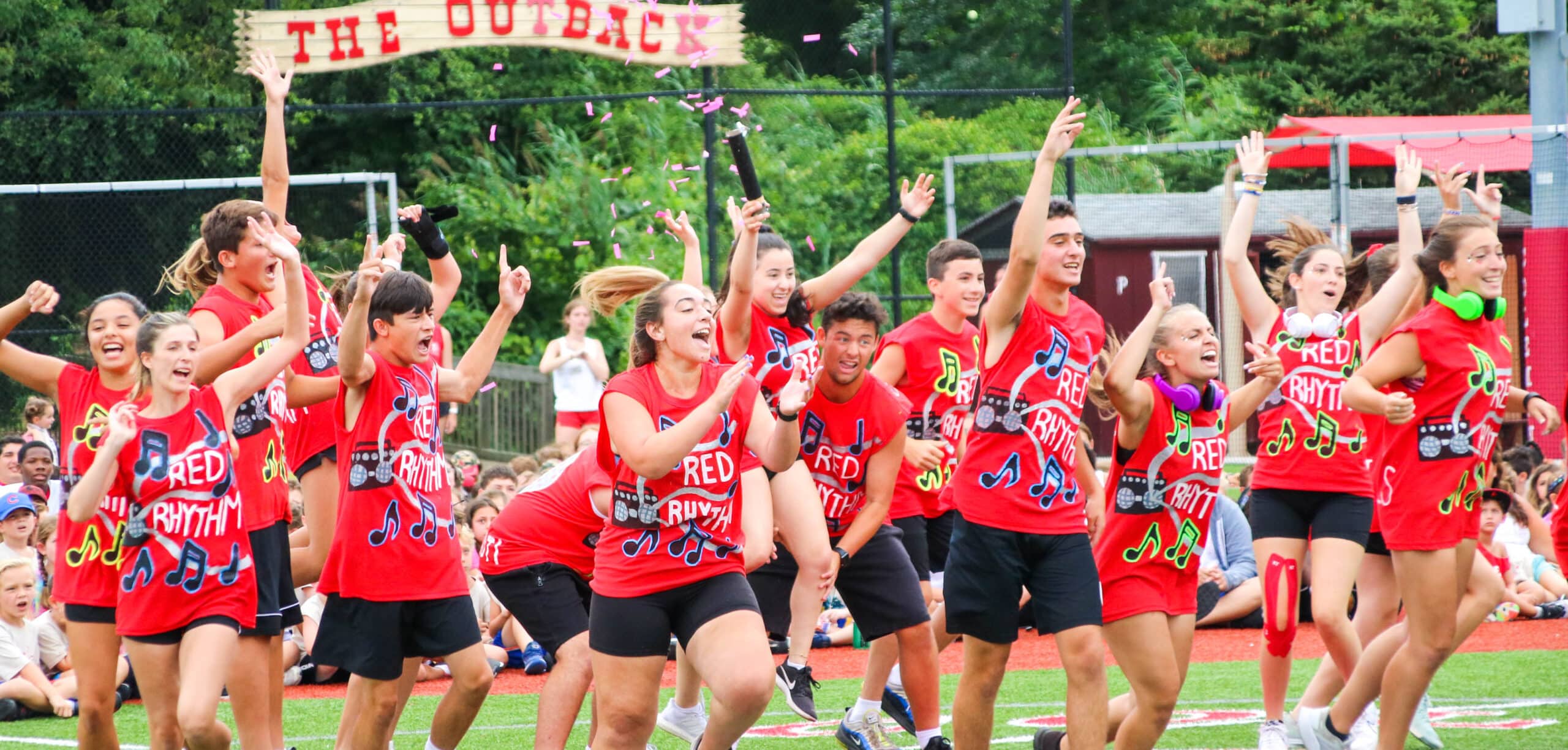 Staff members running on the field.